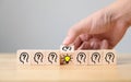 Hand flip over wooden cube block with head human symbol and light bulb icon