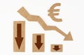 The concept of a crisis in the economy. On a white surface, a graph with down arrows and a euro symbol. Royalty Free Stock Photo