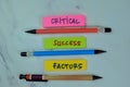 Concept of Critical, Success, Factors write on sticky notes isolated on Wooden Table Royalty Free Stock Photo