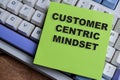 Concept of customer centric mindset write on sticky notes isolated on Wooden Table Royalty Free Stock Photo