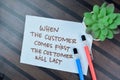 Concept of When The Customer Comes First The Customer Will Last write on sticky notes isolated on Wooden Table Royalty Free Stock Photo