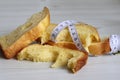 The concept of cut down one`s carbohydrate intake. Bread and a tape measure. Royalty Free Stock Photo