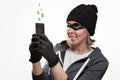 The concept of cybercrime and hacking. Portrait of a woman in a black hat, gloves and mask, who is holding a mobile phone. Dollar