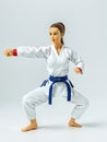 A 3D Toy Of A Sporty Woman Karate Pose On A Bright White Background. Generative AI