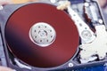 The concept of data, hardware, and information technology, the image of inside of hard disk drive on the technician`s desk and a Royalty Free Stock Photo