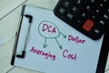 Concept of DCA - Dollar Cost Averaging write on paperwork with calculator isolated on Wooden Table Royalty Free Stock Photo