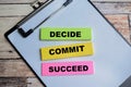 Concept of Decide Commit Succeed write on sticky notes isolated on Wooden Table