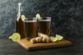 Concept of delicious drink with glasses and bottle of ginger beer on wooden table