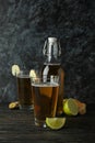 Concept of delicious drink with glasses and bottle of ginger beer on wooden table