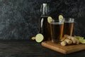 Concept of delicious drink with glasses and bottle of ginger beer on wooden table