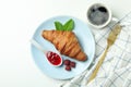 Concept of delicious food with croissant with raspberry jam on white background