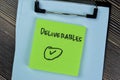 Concept of Deliverables write on sticky notes isolated on Wooden Table