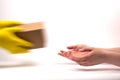 The concept of delivery, package, storage, transfer of the package. A courier dressed in rubber yellow gloves passes the