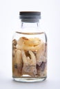 Concept - dentist`s trophy. Set of removed teeth in a glass medical vial with ethyl alcohol. Macro photography