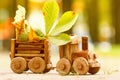 Concept design autumnal mood, yellow foliage on a background and a toy train. Fall October or November. Royalty Free Stock Photo