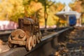 Concept design autumnal mood, yellow foliage on a background and a toy train. Fall October or November. Royalty Free Stock Photo