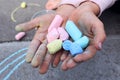 The concept of the development of creativity in children. Colorful chalk for drawing in children`s hands, close-up Royalty Free Stock Photo