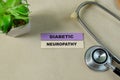 Concept of Diabetic Neuropathy write on sticky notes with stethoscope isolated on Wooden Table Royalty Free Stock Photo