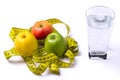 Concept of diet, fresh apples and a glass of water on a light ba Royalty Free Stock Photo