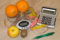 Concept of diet. Low-calorie vegetables diet. Diet for weight loss. Measuring tape and vegetables on the table Royalty Free Stock Photo