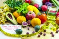 Concept of diet. Vegetables and fruits: Aavakado, figs, feijoa, cleansing the body, healthy eating, waist measuring tape Royalty Free Stock Photo