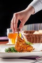 Concept of dinner in Japanese restaurant. Spinach garnish with cream and glazed chicken legs in spicy sauce. Plum wine in glass