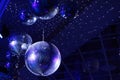 The concept of disco. Light and music disco ball on a blue background. A rotating disco ball in a nightclub with