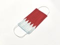 Concept. Disposable medical surgical face mask with Bahrain country flag superimposed on it, on white background. Protection again