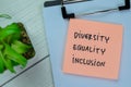 Concept of Diversity, Equality, Inclusion write on sticky notes isolated on Wooden Table Royalty Free Stock Photo