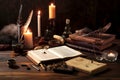 Old books, feather, inkwell and candles on a wooden table. Generative AI Royalty Free Stock Photo