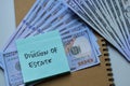 Concept of Division of Estate write on sticky notes with dollar isolated on Wooden Table Royalty Free Stock Photo
