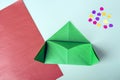 Concept of DIY and kid`s creativity, origami. Step by step instruction: how to make bookmark as christmas tree. Step 4 Bend