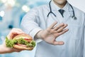 Concept of a doctor prohibiting eating fast food