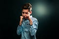 The concept of domestic violence. The boy folded his fists and defends himself against aggression. Black background. Copy space Royalty Free Stock Photo