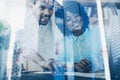 Concept of double exposure.Two young coworkers working together in a modern office.Black business partners discussing Royalty Free Stock Photo