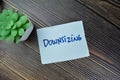 Concept of Downsizing write on sticky notes isolated on Wooden Table