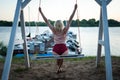 The concept of dreams and happiness, a romantic beautiful carefree woman relaxing on a swing on the beach