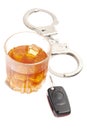 Concept for drinking and driving. Whiskey with car keys and handcuffs. Royalty Free Stock Photo