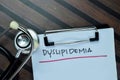 Concept of Dyslipidemia write on paperwork isolated on Wooden Table