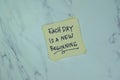 Concept of Each day is A new Beginning write on sticky notes isolated on Wooden Table Royalty Free Stock Photo