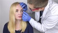 An ophthalmologist examines a woman who complains of a burning sensation and pain in her eyes. Eye fatigue from a computer screen