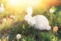 The concept of Easter holidays. Decorative handicraft handmade product in the form of a lying white rabbit, located next to the