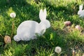 The concept of Easter holidays. Decorative handicraft handmade product in the form of a lying white rabbit, located next to the