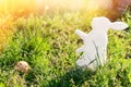 The concept of Easter holidays. Decorative handmade craft in the form of a rabbit, located next to the painted egg. Green grass in Royalty Free Stock Photo