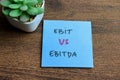 Concept of Ebit vs Ebitda write on sticky notes isolated on Wooden Table Royalty Free Stock Photo