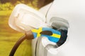 Charging electric vehicles with an electric cable with the image of the flag of Sweden