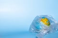 The concept of ecology. Globe in plastic wrap on a blue background. plastic waste environmental pollution concept Royalty Free Stock Photo