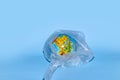 The concept of ecology. Globe in plastic wrap on a blue background. plastic waste environmental pollution concept Royalty Free Stock Photo