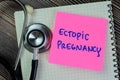 Concept of Ectopic Pregnancy write on sticky notes with stethoscope isolated on Wooden Table