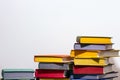 Concept of education and preparation for school. Split-level of colorful book stacks on the white background.